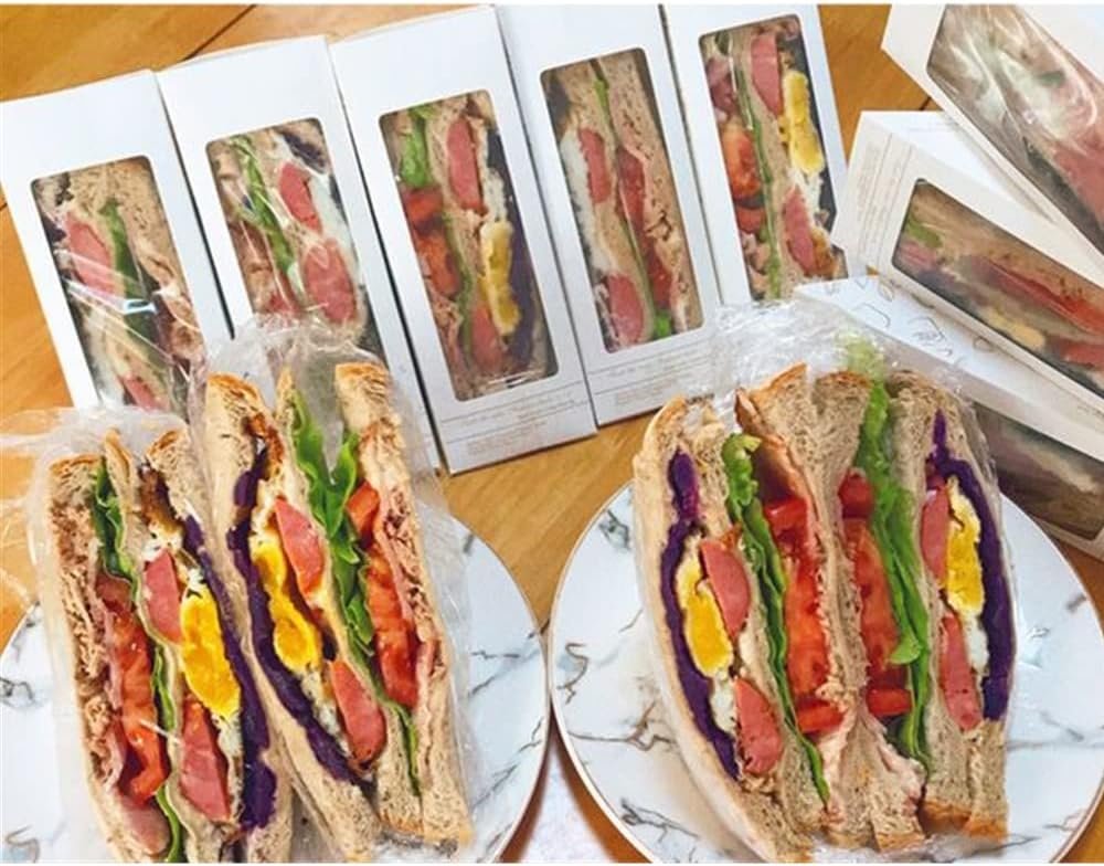 Caja de sándwiches de 100 piezas, biodegradable y con ventanilla para exhibición, ideal para servicio de comida para llevar en panaderías. Logo personalizado disponible con marca blanca. Proveedor de soluciones ecológicas.